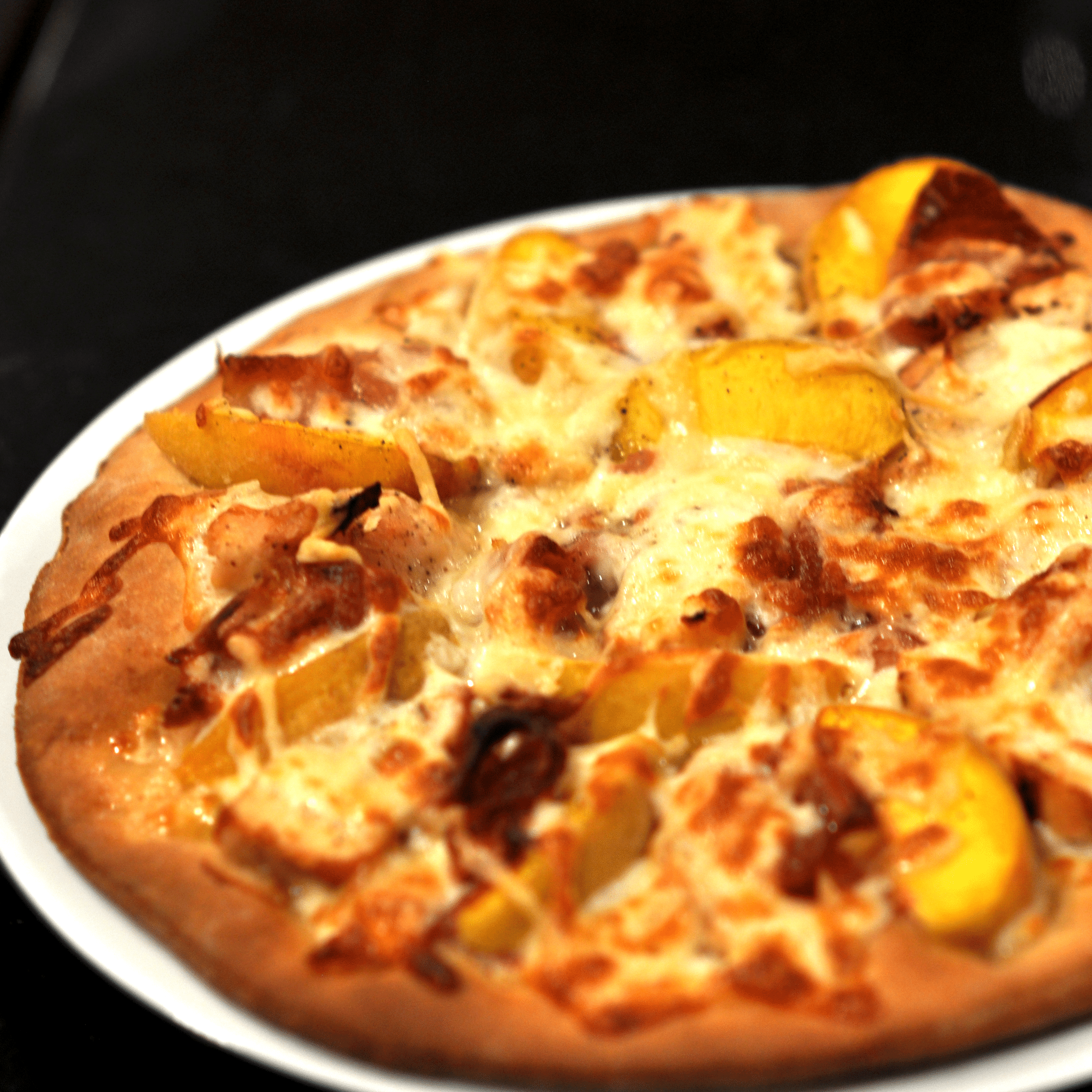 Onion Confit flatbread with Peachs and Proscuitto